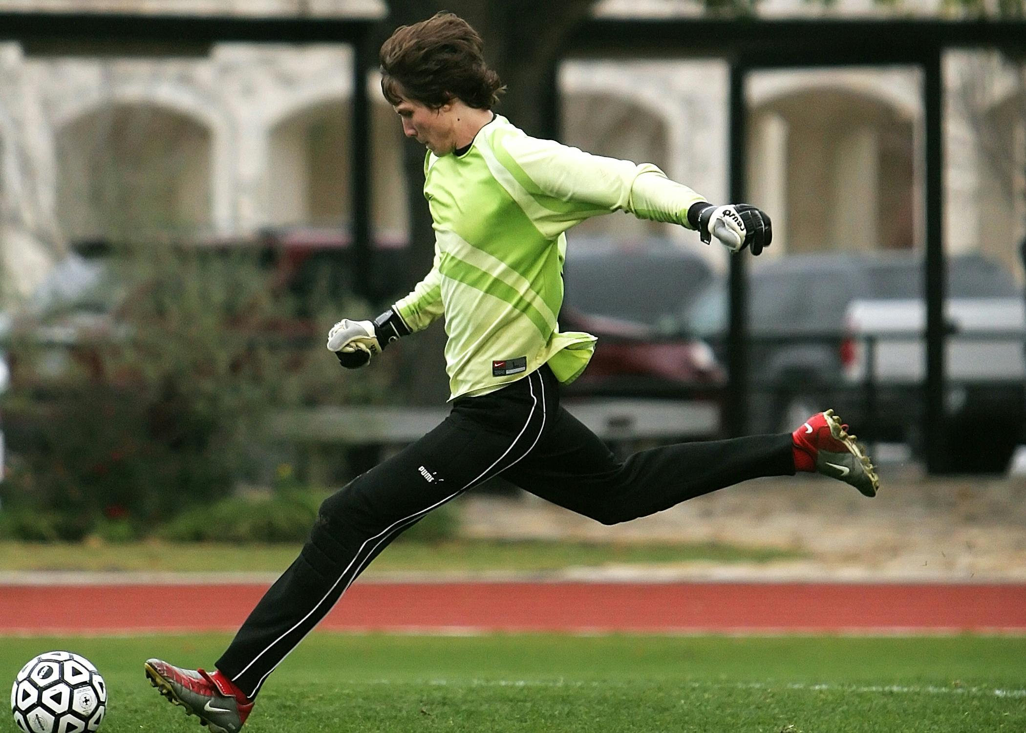 A goalkeeper kicking a soccer ball | Source: Pexels