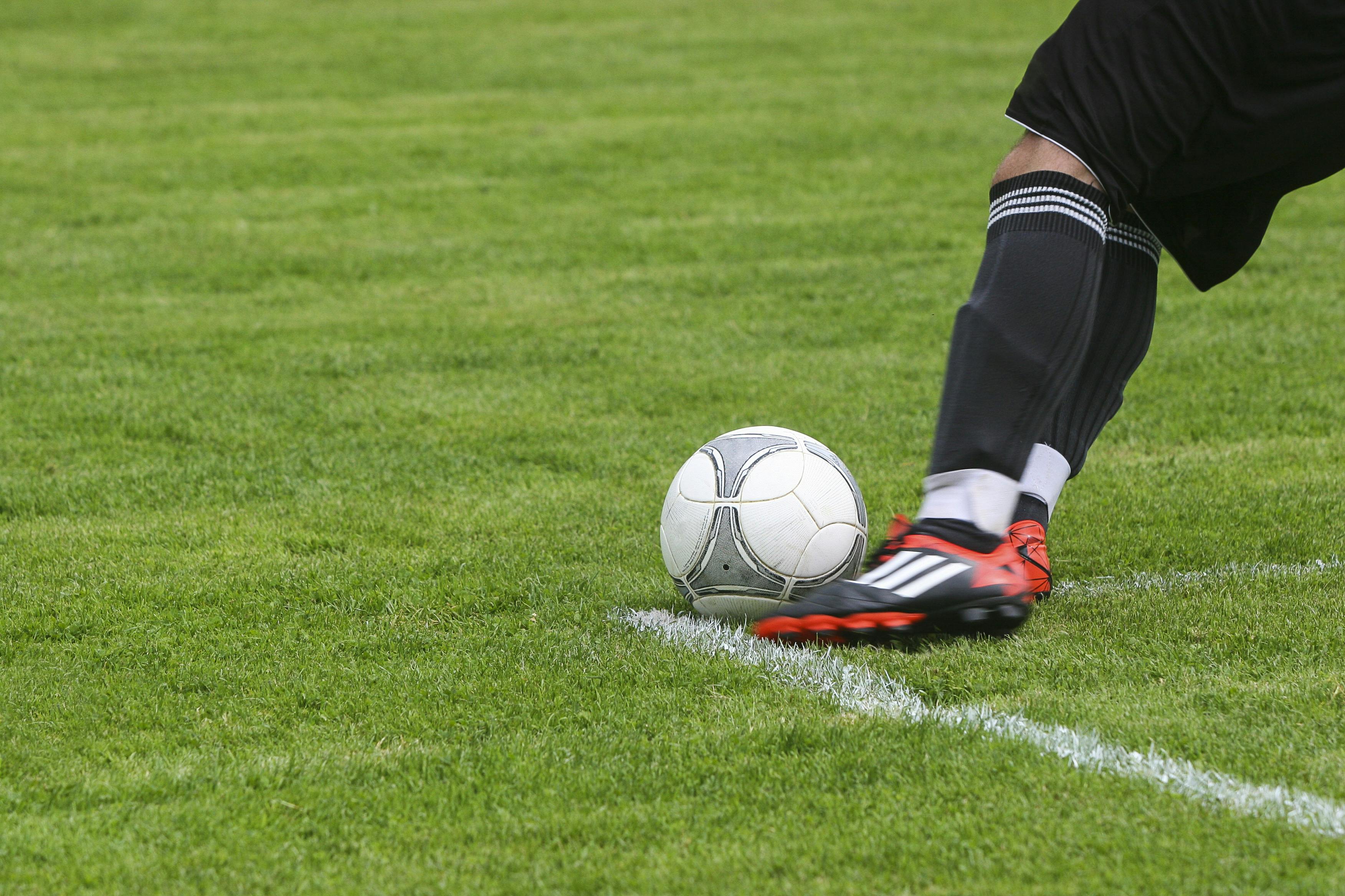 Person kicking a soccer ball | Source: Pexels